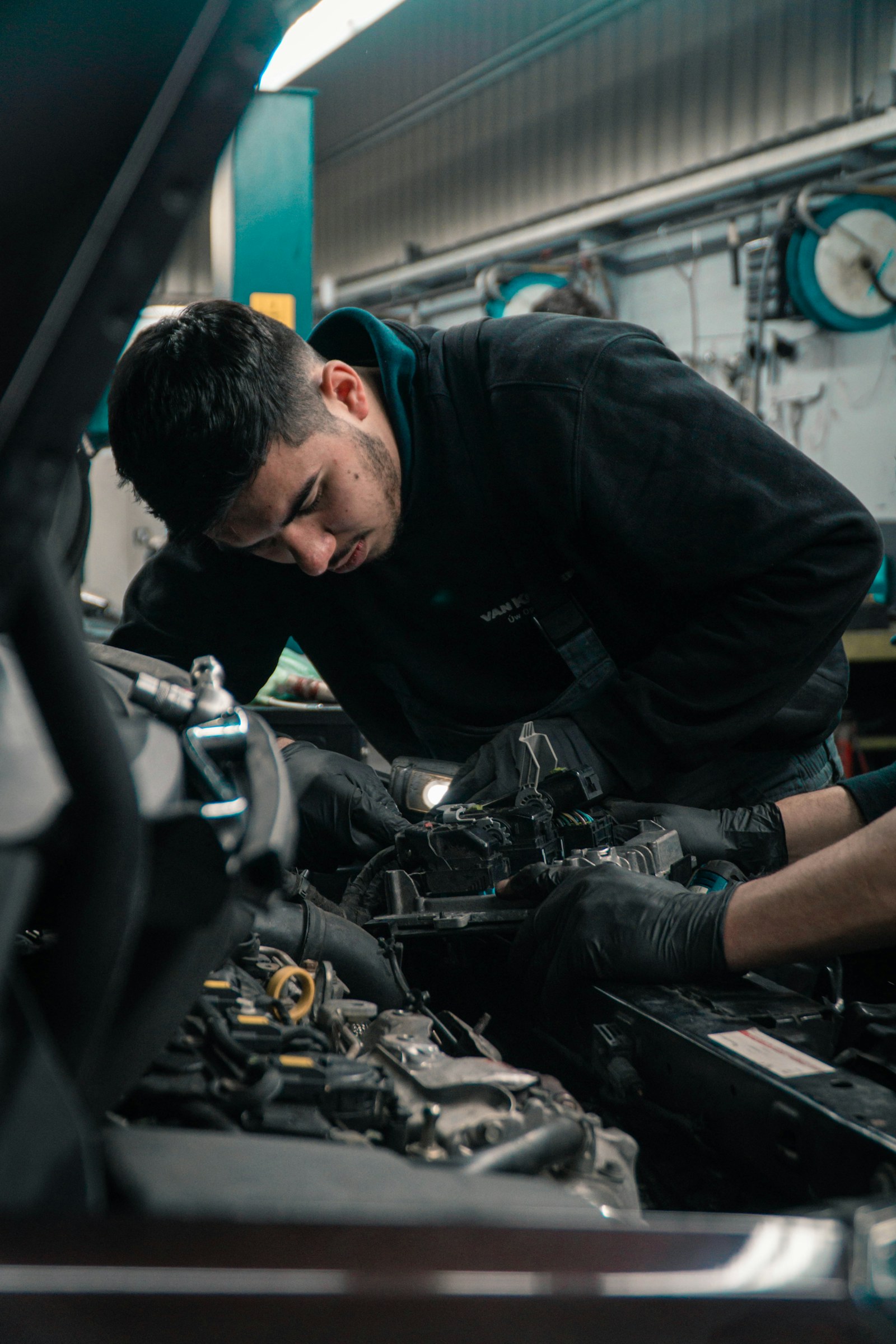Technician inspecting an engine with gloved hands