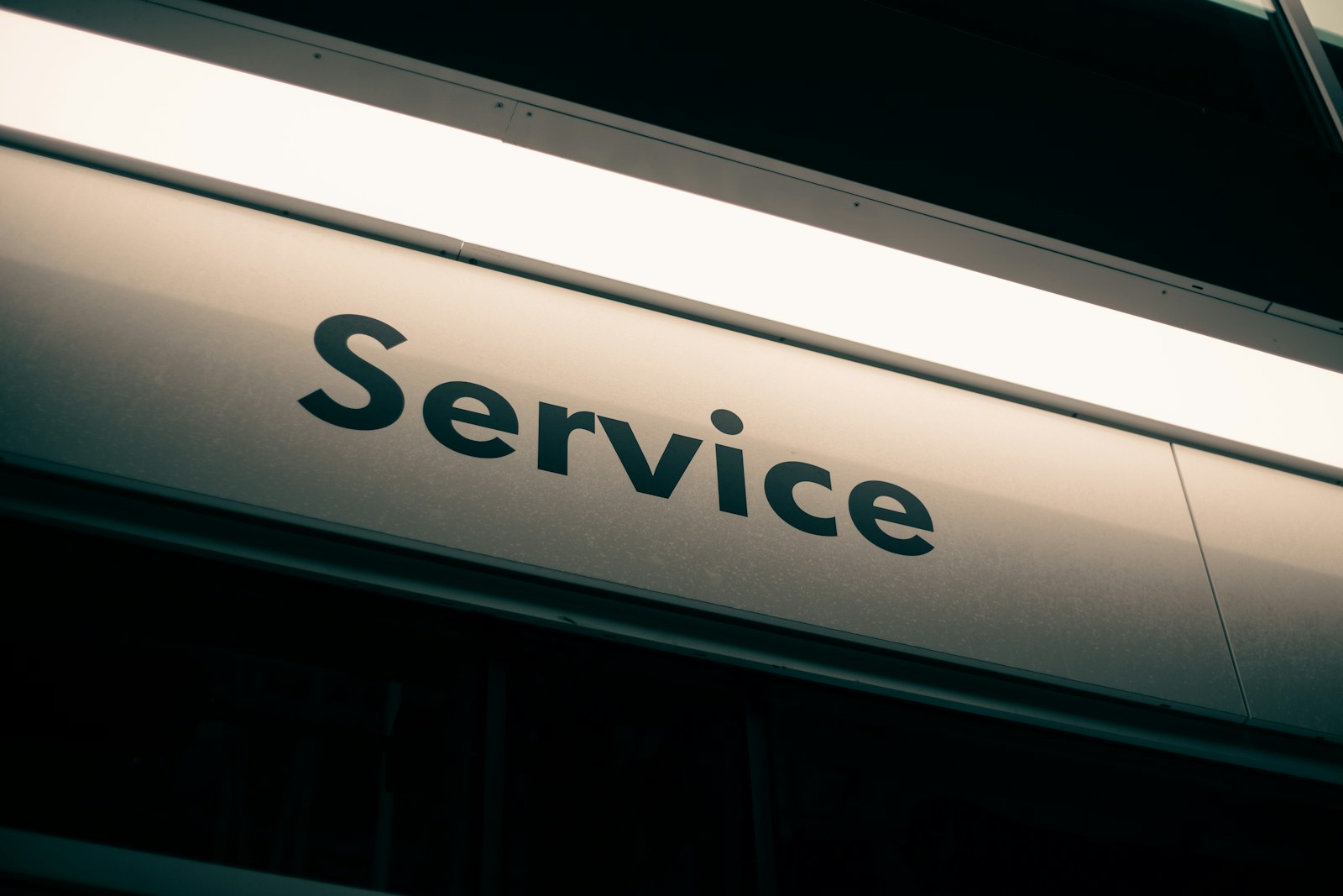 Illuminated Service sign in a dark workshop